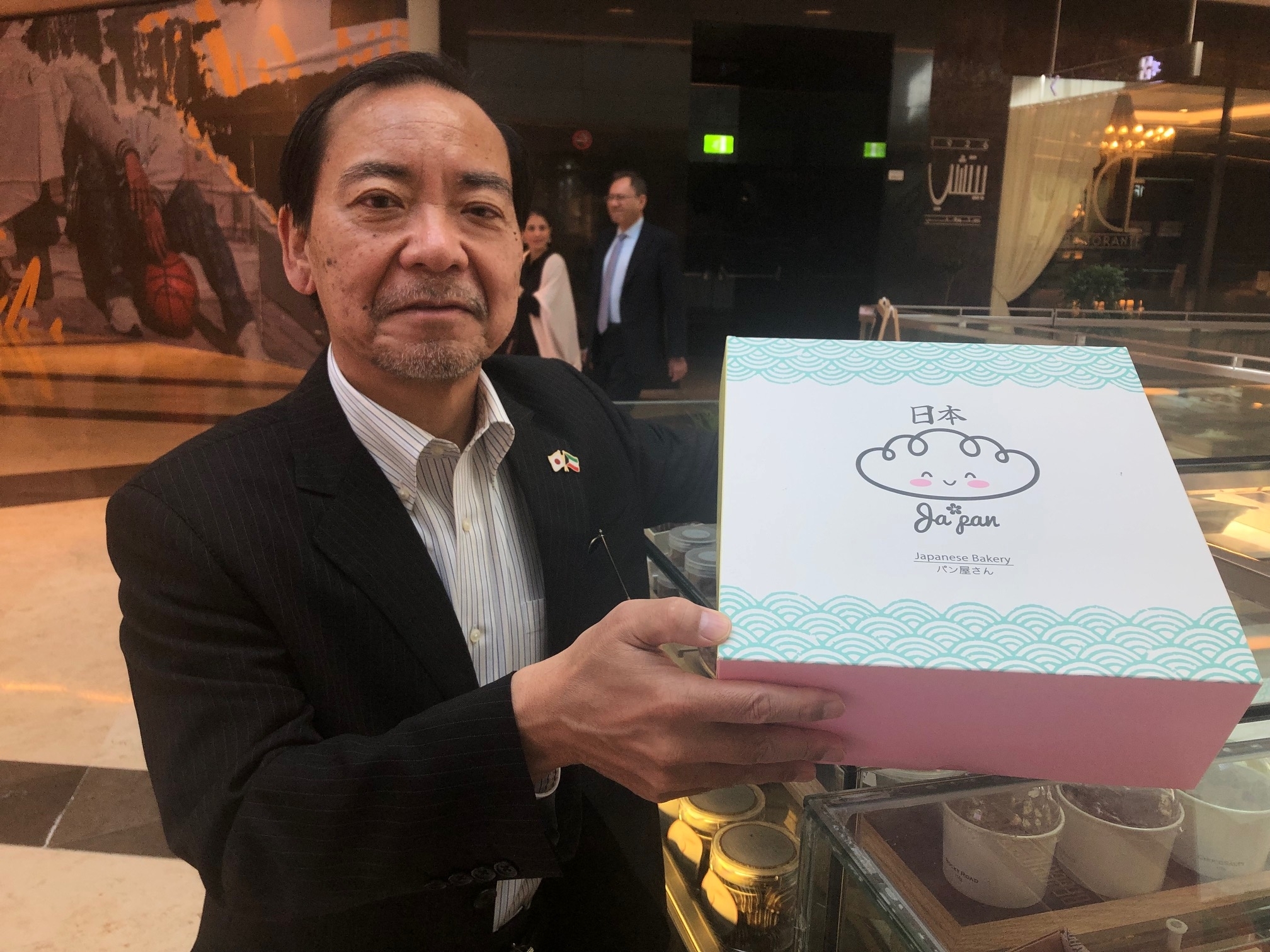 ambassador holding cake